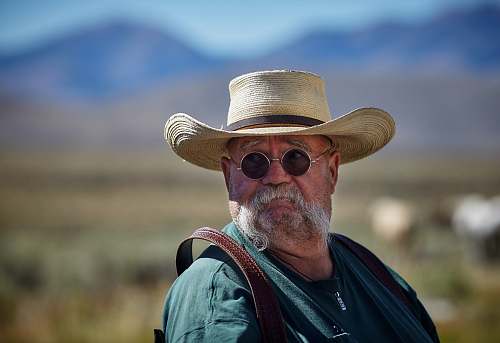 person shallow focus of man wearing sunhat hat