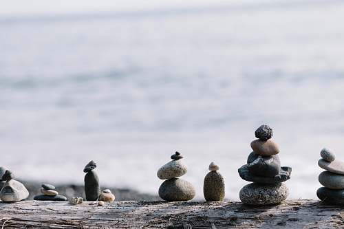 person shallow focus photo of balance stones pebble