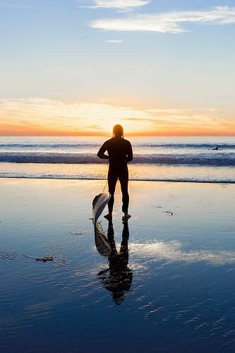 person silhouette of man beside body of water people