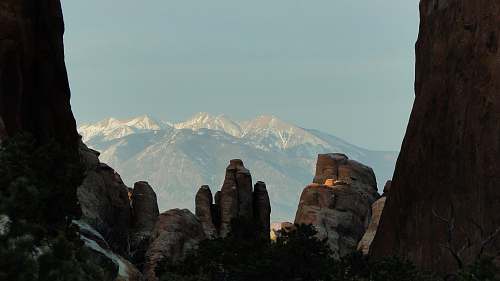 grey white snow on mountains behind canyon person