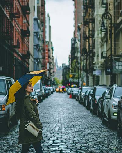 umbrella woman holding umbrella surrounded by cars canopy