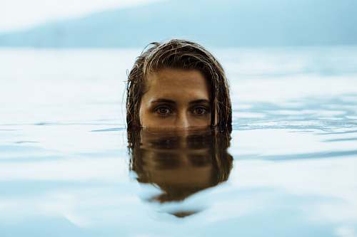 people woman in body of water during daytime person