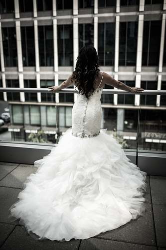 wedding woman in white wedding dress standing in front balustrades bride