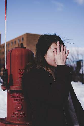 person woman leaning beside red fire hydrant oakland university