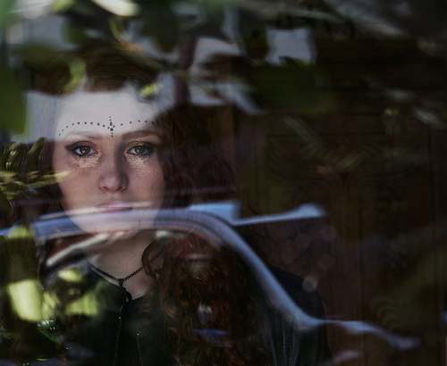 person woman looking at glass during daytime people