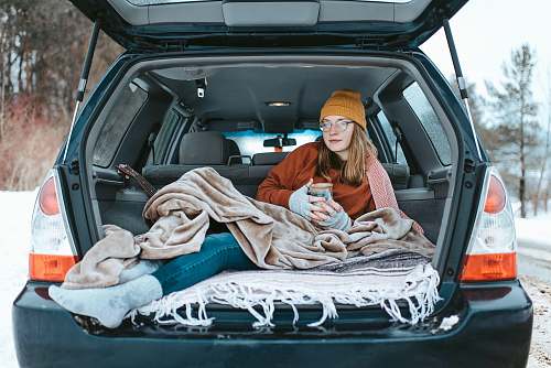 people woman lying down on car compartment person