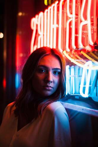 person woman near red LED sign light