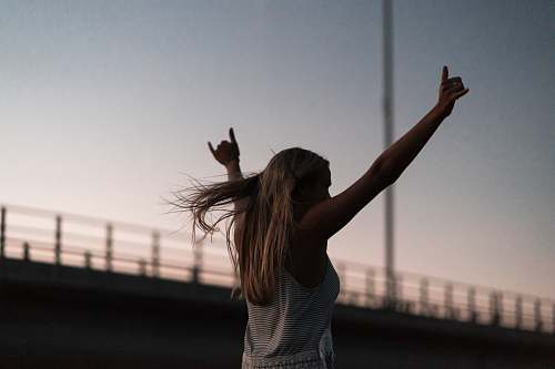 person woman raising his hands during daytime people