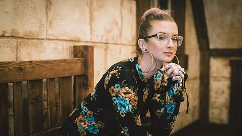 people woman sitting on bench puts her elbow on her lap posing person