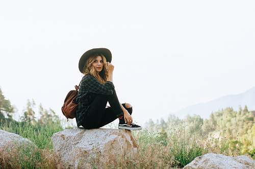 people woman sitting on rock in forest person