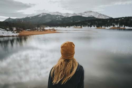 apparel woman standing while wearing brown knit cap clothing