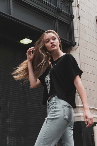 apparel woman walking near building clothing