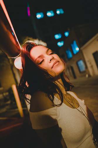 person women wearing white cold-shoulder shirt during night time people