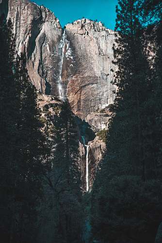 mountain waterfalls on rock mountain cliff