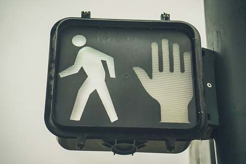 grey black go and stop pedestrian signage broadway