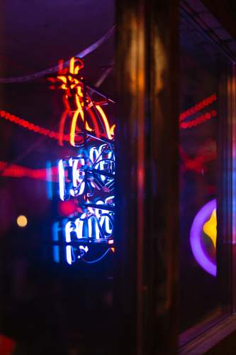 neon blue, red, and orange neon signage turned-on printers alley