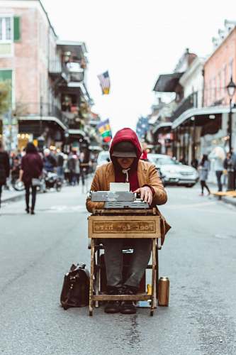 suitcase man sitting on table typing on typewriter human