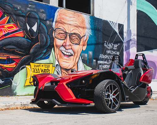 wheel red and black sports car beside wall spoke