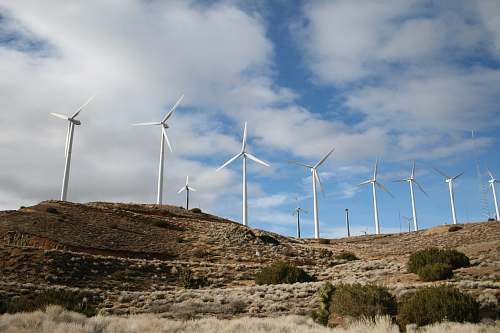 motor white wind turbines during daytime turbine