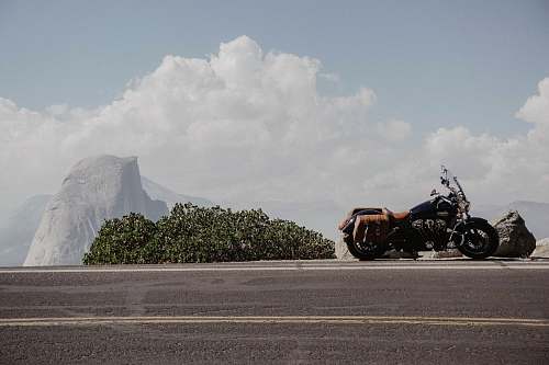 transportation black cruiser motorcyle beside a black road vehicle