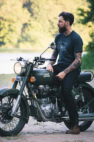 transportation man sitting on black motorcycle vehicle