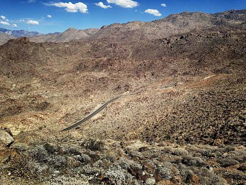 road aerial photography of winding road on brown mountain ca-74