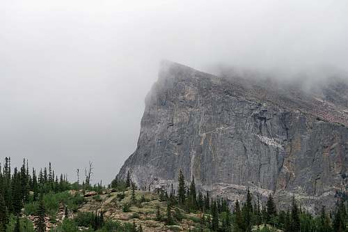 grey mountain covered by fog mountain range
