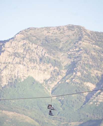 utah pair of brown Vans Sk8-Hi hanged on rope snow