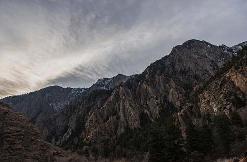 nature rugged mountain under white cloud blue skies outdoors