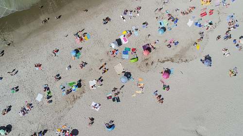 ocean aerial photo of people sunbathing on the beach beach
