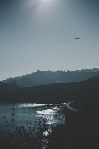 outdoors aerial photography of body of water and mountains grey