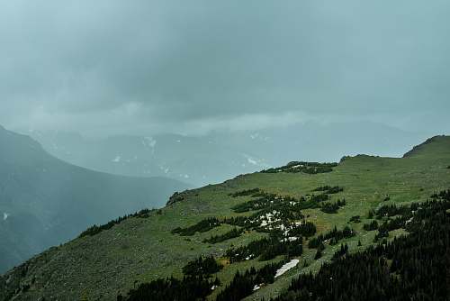 outdoors aerial photography of mountain under cloudy sky slope