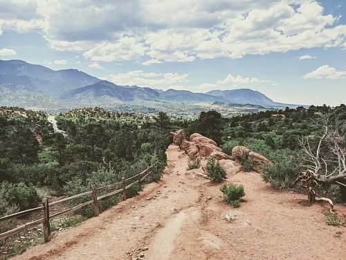 outdoors brown dirt road with brown wooden fence during daytime ground