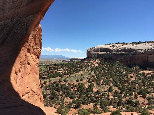 outdoors brown rock formation under blue sky during daytime mesa