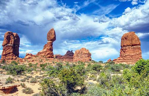 outdoors brown rock formations near grass mountain