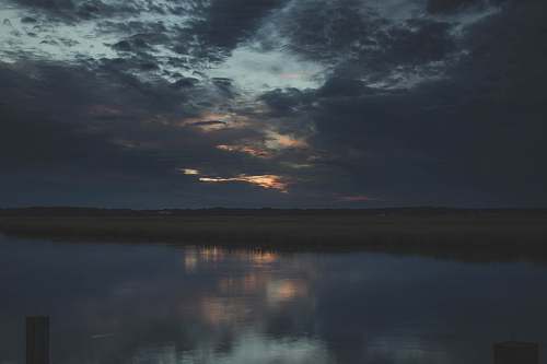 outdoors calm body of water under gray skies water