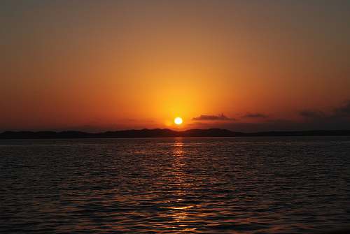 outdoors calm sea during sunset sunlight