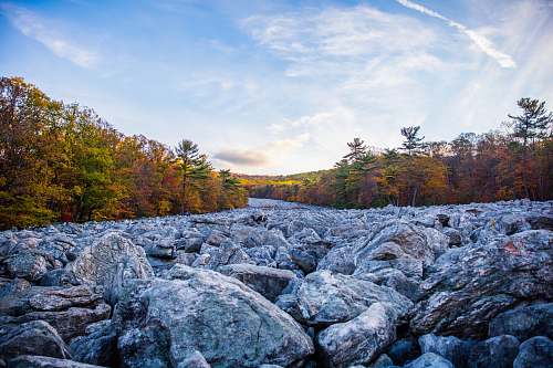 rock gray stones and brown trees under white and blue sky blue rocks family campground