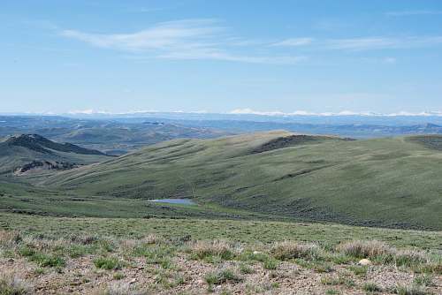 outdoors green hills under blue sky grass