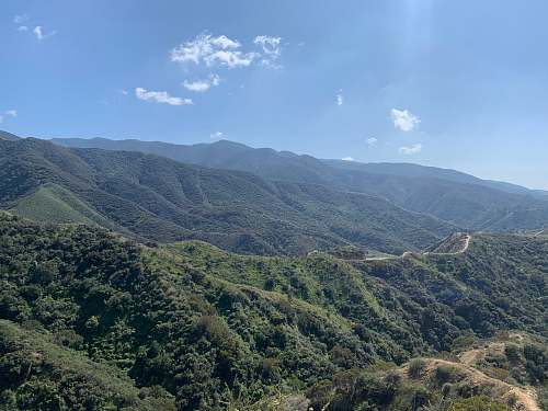 outdoors green mountains under blue sky during daytime countryside