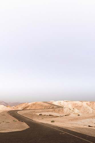 desert grey asphalt road on desert during daytime death valley