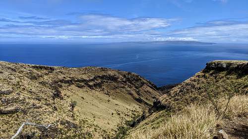 outdoors high-angle photography of mountains under clear blue sky land