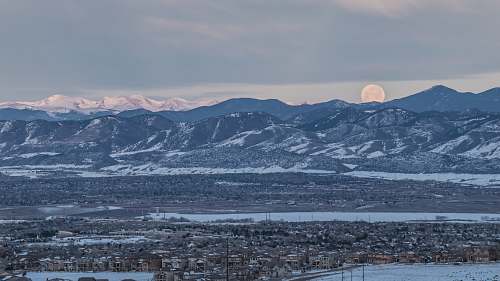 outdoors landscape photo of snow covered mountains under cloudy sky mountain