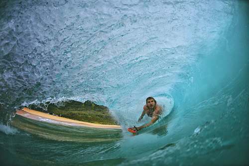 surfing man surfing in wave on water ocean