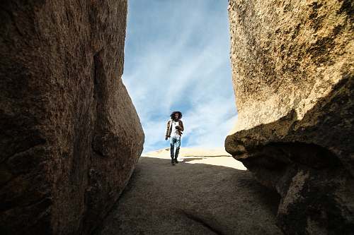 human man walking near rock person