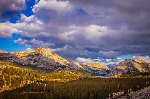 sky mountains and trees under blue and white sky at daytime photography cloud