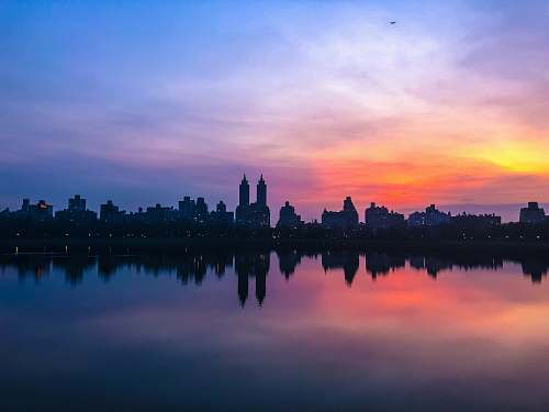 outdoors panoromic photographic of city buildings sunset