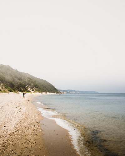promontory people on beach during daytime ocean