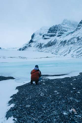 outdoors person siting facing mountain mountain
