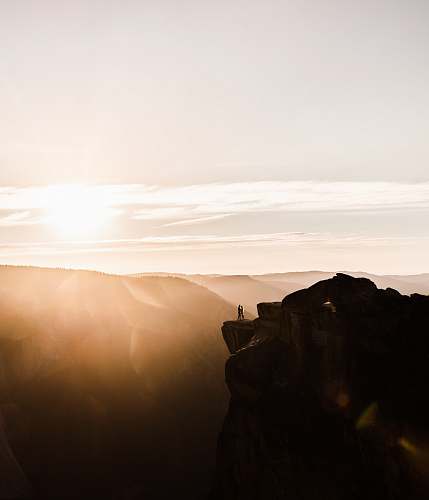 light person standing on rock formation flare